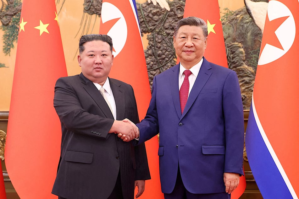 Chinese President Xi Jinping (r.) and Democratic People's Republic of Korea leader Kim Jong Un shake hands at the Great Hall of the People in Beijing on September 4, 2025.