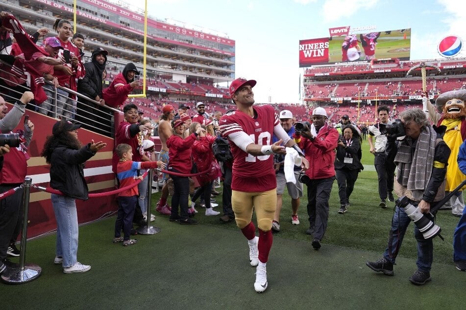 Jimmy Garoppolo tosses his towel to fans after the 49ers' 27-7 win against the Seattle Seahawks.