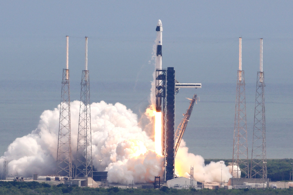 A SpaceX rocket soared into the sky Saturday with two passengers on board, leaving two seats empty to return American astronauts who have been stranded for months on the International Space Station, NASA said.