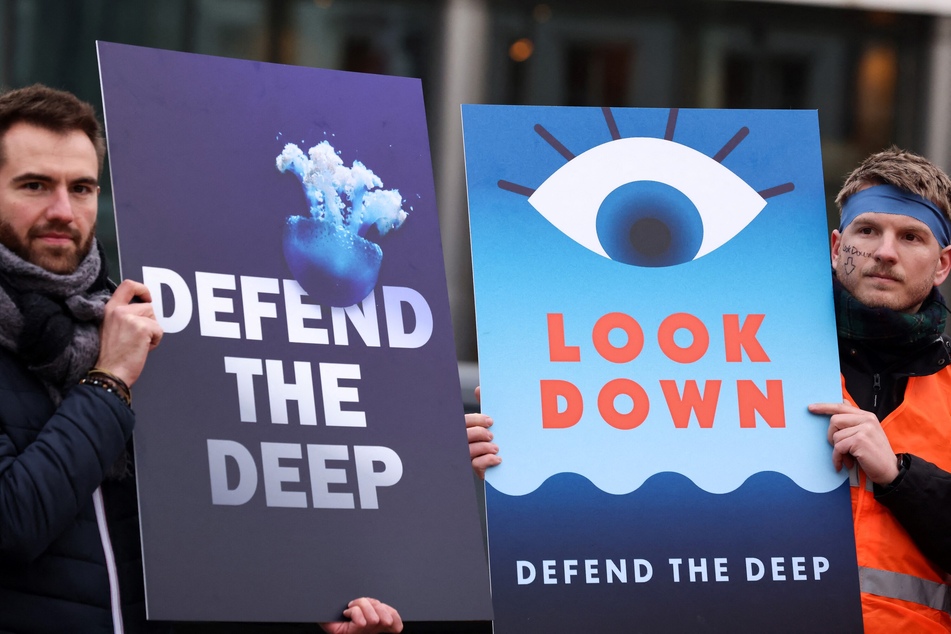 Activists take part at a "Look Down" rally to stop deep-sea mining outside the European Parliament in Brussels, Belgium.