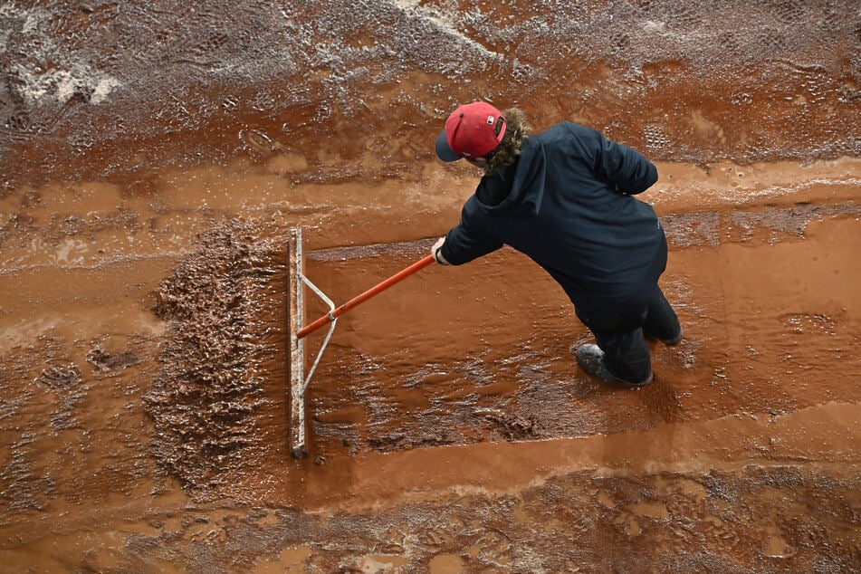 The grounds crew work on the warning track before game four of the ALCS between the Tampa Bay Rays and the Cleveland Guardians on October 16, 2026, before it was postponed.