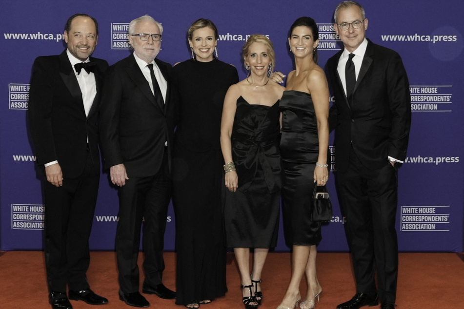 Philip Rucker, Wolf Blitzer, Pamela Brown, Dana Bash, Kaitlan Collins, and Jeff Zeleny pose on the red carpet upon arrival for the annual White House Correspondents' Association Dinner on April 26, 2025.