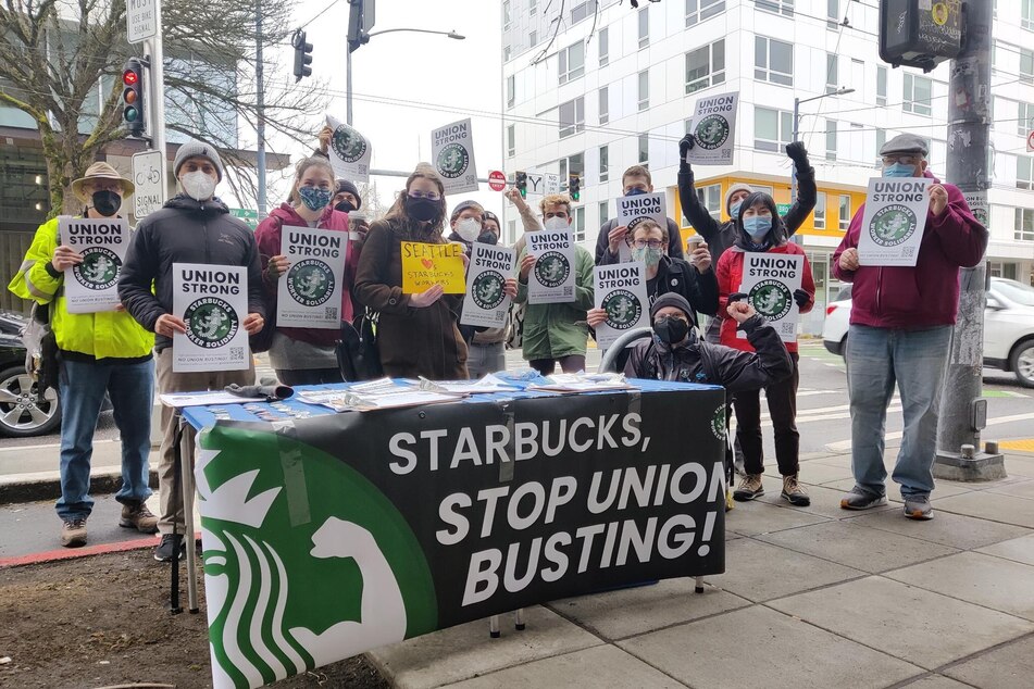 Starbucks workers and allies protest the company's union-busting tactics outside the Broadway and Denny store.