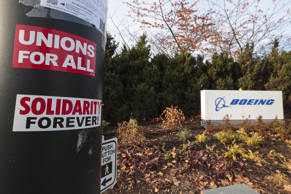 Pro-union stickers are pictured on a pole outside the Boeing Renton Production Facility in November 2024. The Society of Professional Engineering Employees in Aerospace has ratified its contract for US workers.
