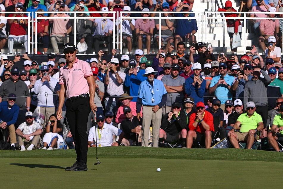 Justin Thomas putts on the 17th green in a three-hole playoff against Will Zalatoris.