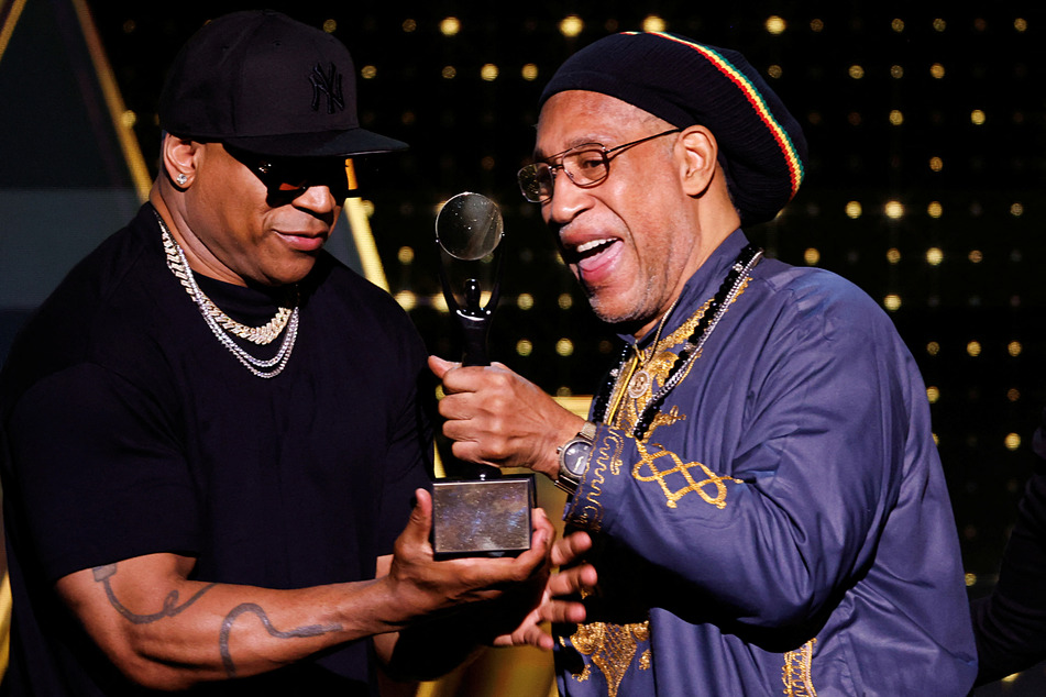 DJ Kool Herc receives the Musical Influence Award from LL Cool J during the 38th Annual Rock & Roll Hall of Fame Induction Ceremony.