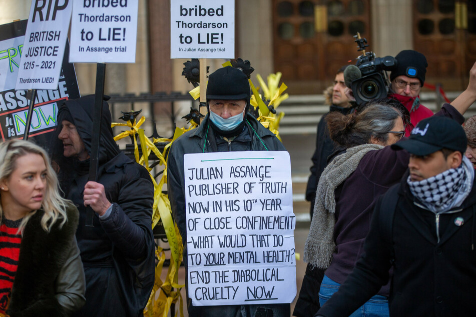 Protesters gather outside the High Court in London to demand the release of WikiLeaks founder Julian Assange.