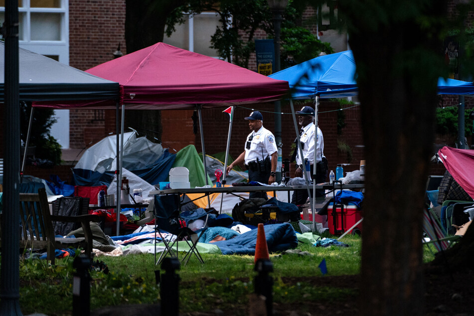 Law enforcement officers walk through a now empty Pro-Palestinian encampment at George Washington University's University Yard on Wednesday in Washington, DC.