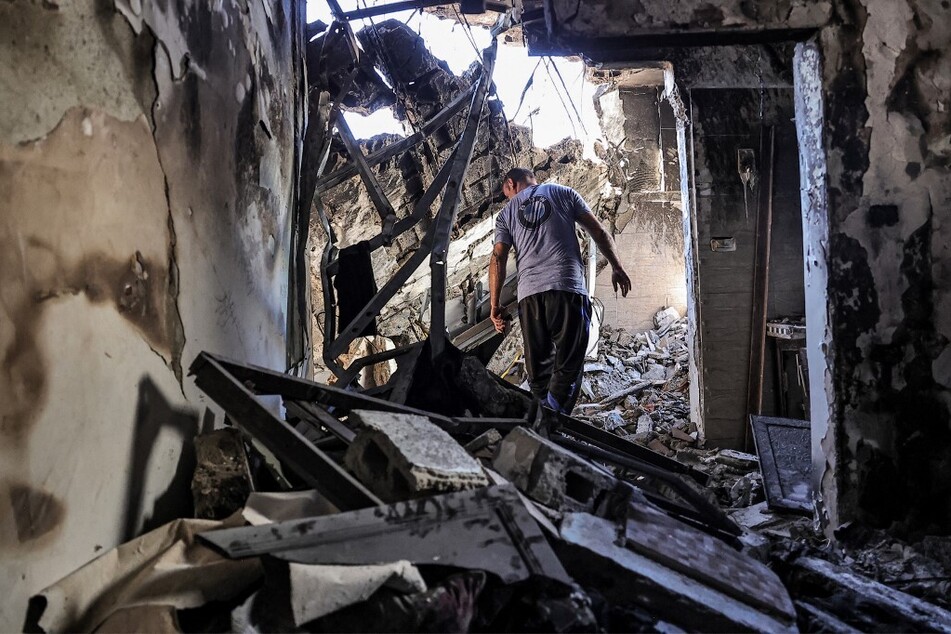 People search the rubble of a building hit by bombardment at the Nur Shams camp for Palestinian refugees, east of Tulkarm in the occupied West Bank.