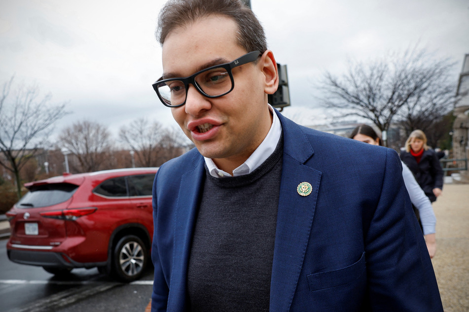 New York Rep. George Santos speaks to reporters as he leaves the Longworth House Office building on Capitol Hill.