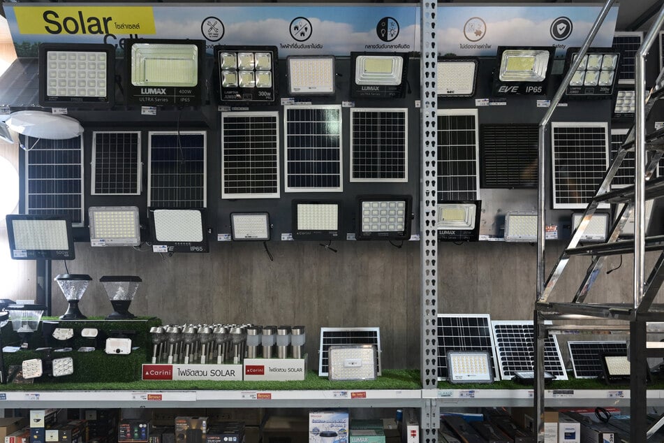 Small solar panels and solar-powered lights are displayed for sale at a home improvement center in Bangkok, Thailand.