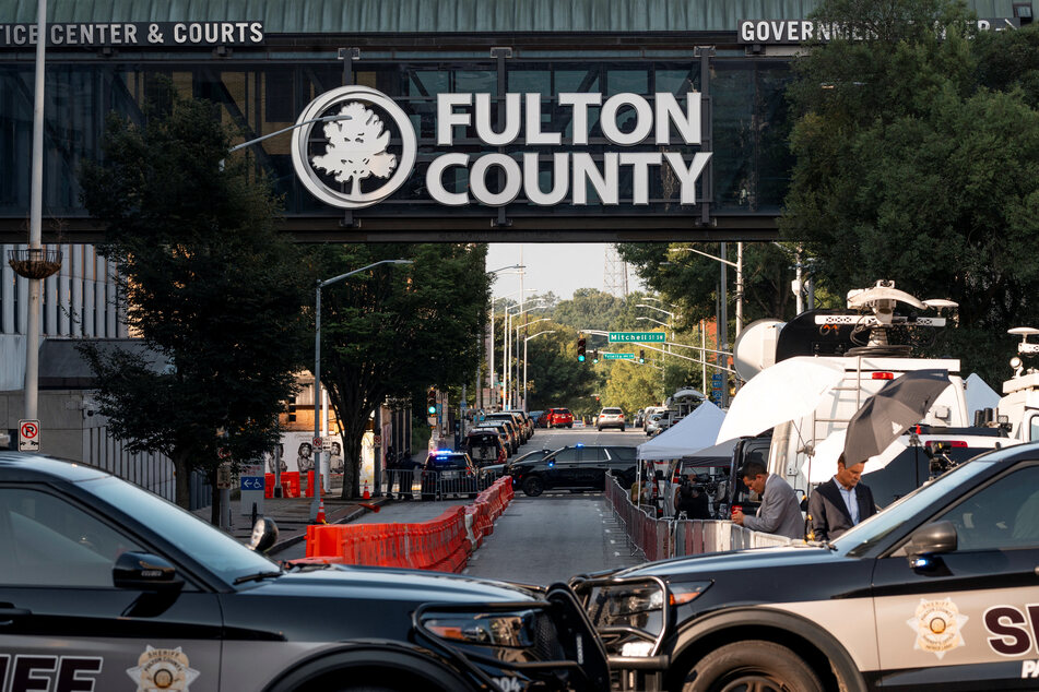 Law enforcement officers block the street to the Lewis R. Slaton Courthouse after a grand jury brought back indictments against former president Donald Trump and 18 of his allies in their attempt to overturn the state's 2020 election results.