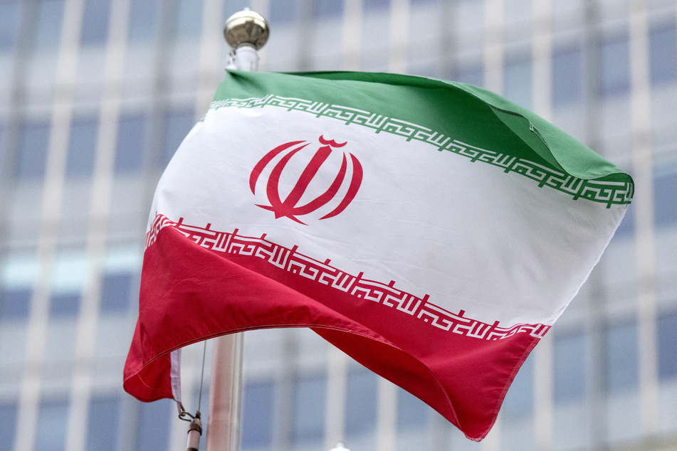 The flag of Iran flutters in the wind outside of the IAEA headquarters in Vienna, Austria.