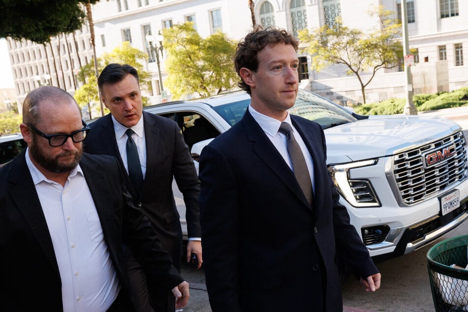 Meta CEO and Chairman Mark Zuckerberg (R) arrives at Los Angeles Superior Court ahead of a social media trial in Los Angeles, on February 18, 2026.