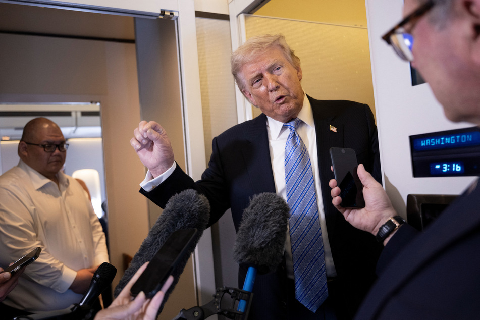President Donald Trump speaks to reporters aboard Air Force One after his departure from Beijing Capital Airport on May 15, 2026.