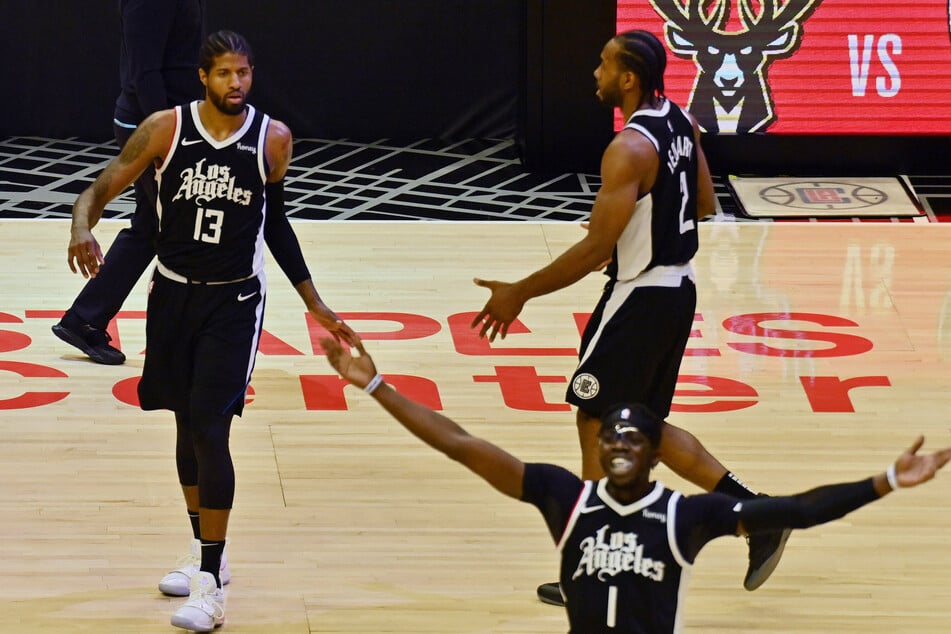 Los Angeles Clippers guard Paul George (13), forward Kawhi Leonard (2), and guard Reggie Jackson (1) celebrate the win.