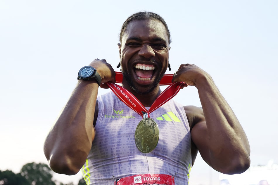 Noah Lyles celebrates with his medal after winning the Men's 100m final during the USATF Outdoor Track & Field Championships at Icahn Stadium on July 24, 2026.