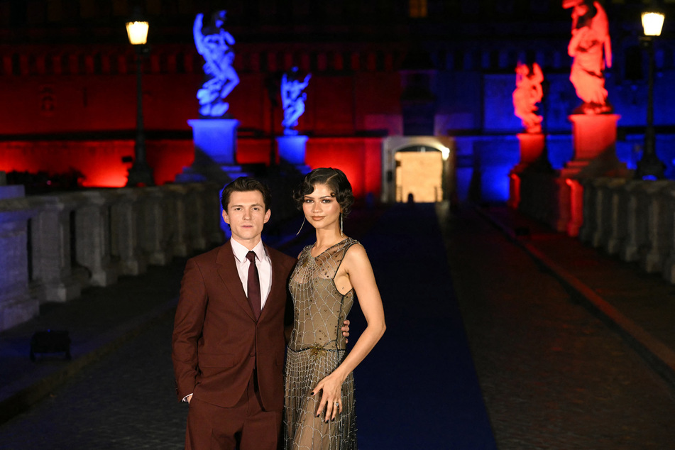Zendaya's (r) stylist addressed the rumors that she and Tom Holland (l) will have a second wedding ceremony that's more public.