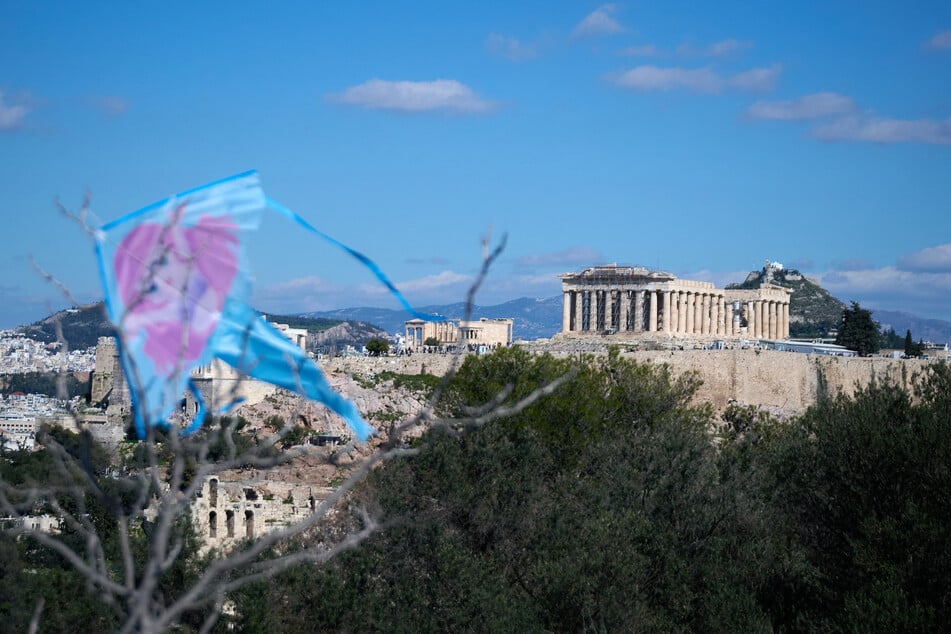 Two Greek-American tourists were injured during a knife attack at the base of the Acropolis.
