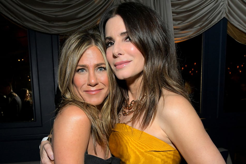 Sandra Bullock (r) said she leaned on friends like Jennifer Aniston to navigate the heartbreak.
