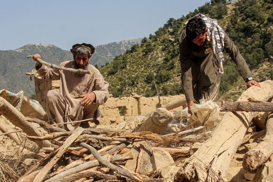 Afghan men salvage from the rubble of houses destroyed by a Pakistan airstrike in the Shultan district of Afghanistan's Kunar province on October 1, 2026.