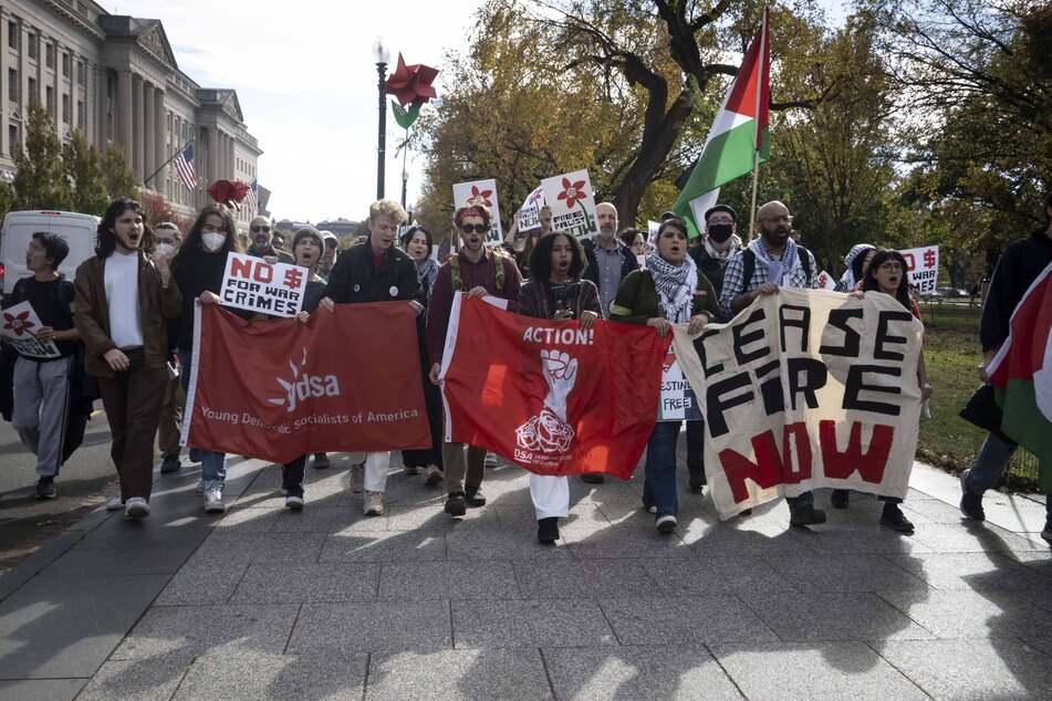 Young Democratic Socialists of America activists join a larger coalition of protesters near the Washington Monument, advocating for an immediate and lasting ceasefire in Gaza.