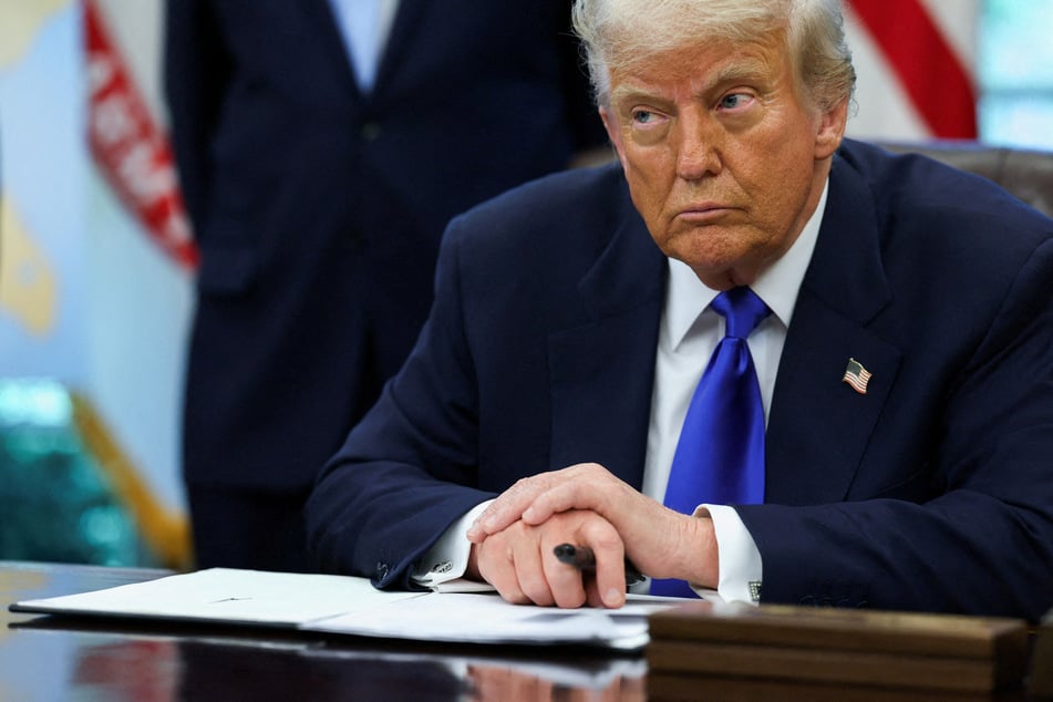 President Donald Trump signs an executive order placing new limitations on biological research in the Oval Office on May 5, 2025.