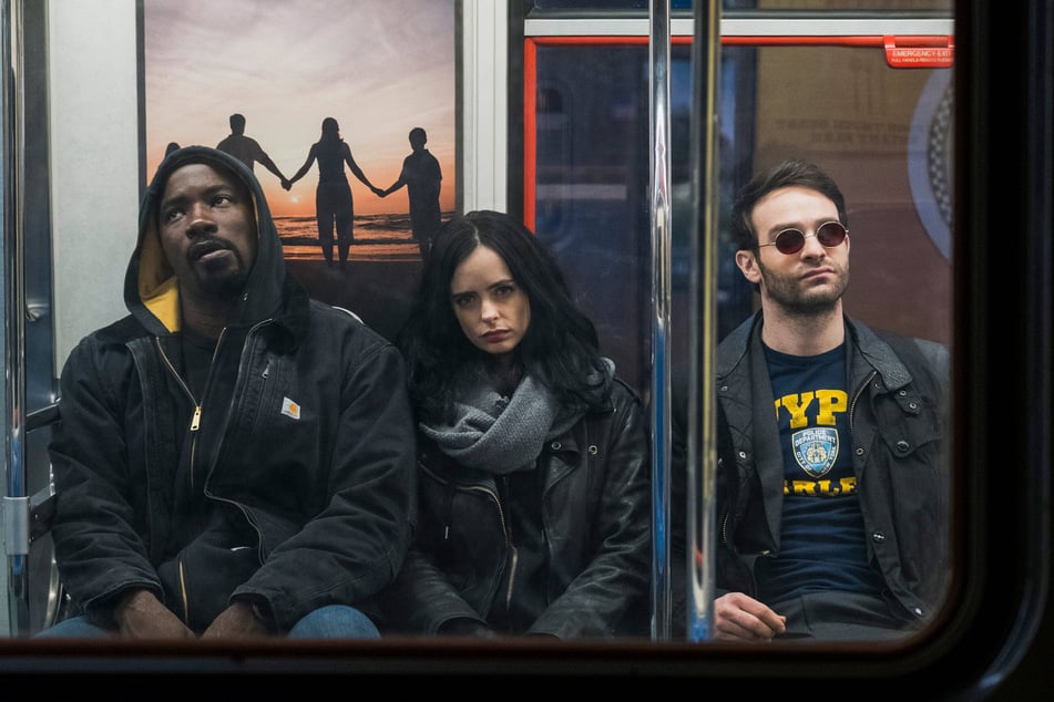 (From l. to r.) Mike Colter, Krysten Ritter, and Charlie Cox in season one of Netflix's The Defenders. The superhero crew, along with Finn Jone as Iron Fist, will return in Daredevil: Born Again.