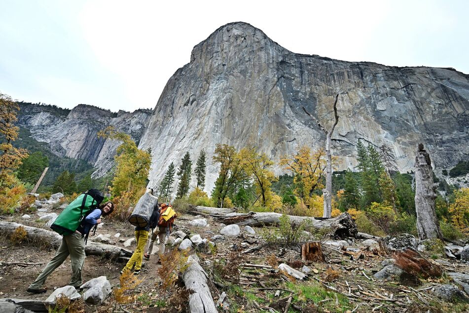 Rock climbers make their way to the base of El Capitan at Yosemite National Park, California, on October 26, 2025, amid the ongoing US government shutdown.