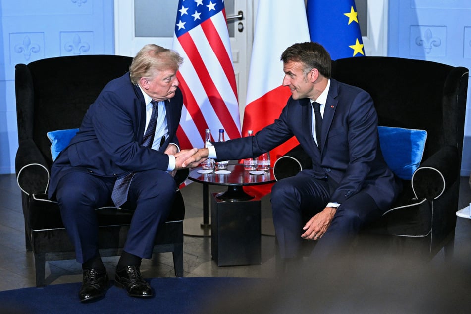 US President Donald Trump (L) shakes hands with France's President Emmanuel Macron (R) during a bilateral meeting on the sidelines of the G7 summit, in Evian, central-eastern France on Monday.