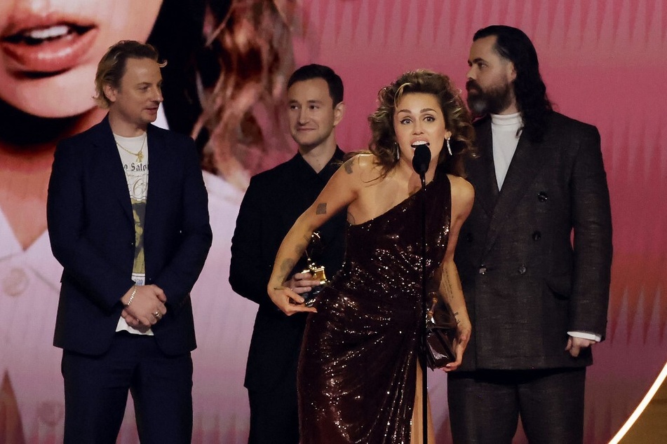 Miley Cyrus speaks onstage during the 66th Grammy Awards.