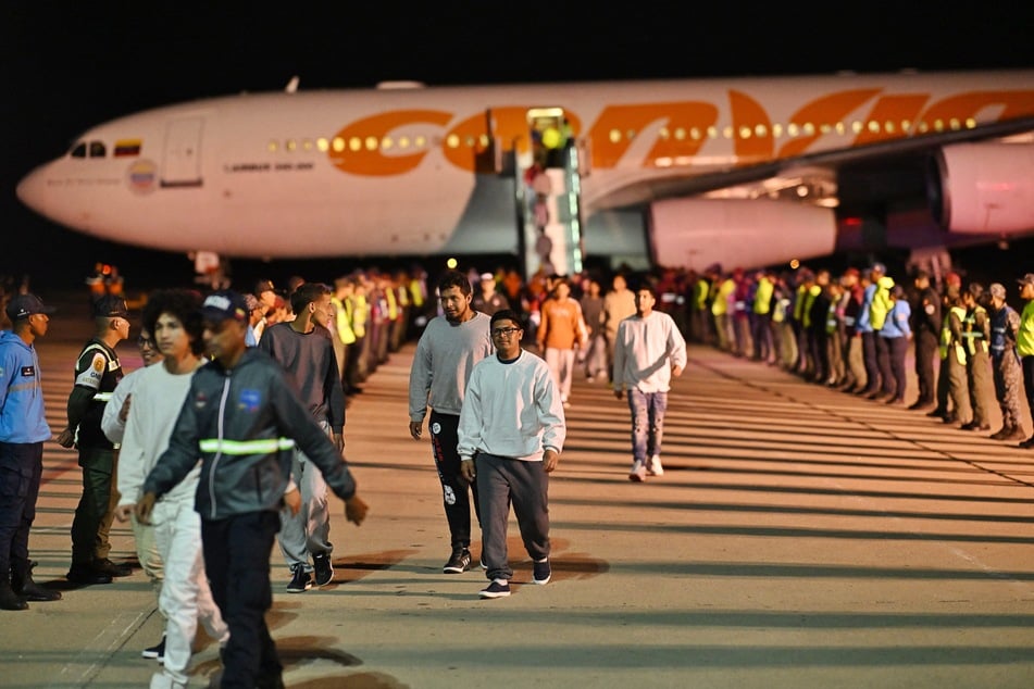 Venezuelan migrants deported from the United States and stranded in Honduras disembark from a Conviasa Airlines plane upon arrival at Simon Bolivar International Airport in Maiquetia, Venezuela on Monday.
