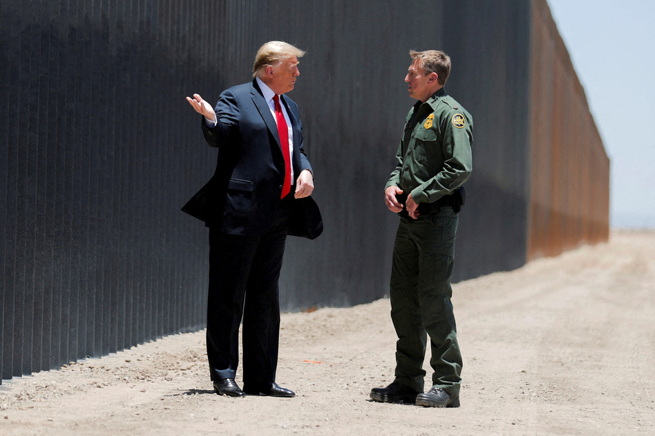 President Donald Trump talks with then Border Patrol Chief Rodney Scott as he tours a section of the US-Mexico border wall in San Luis, Arizona, on June 23, 2020.