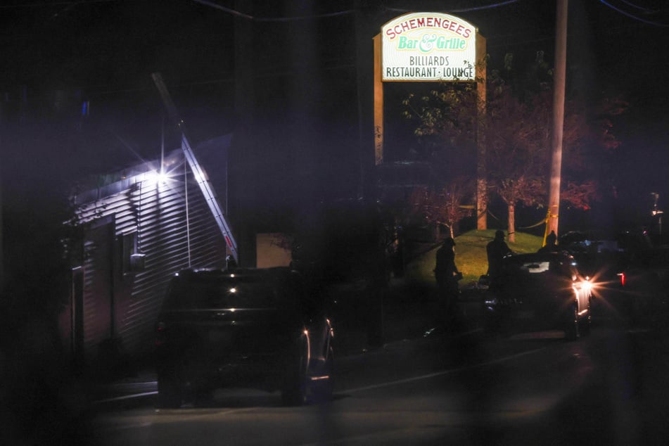 Law enforcement personnel work at the Schemengees Bar & Grille Restaurant after deadly mass shootings in Lewiston, Maine.