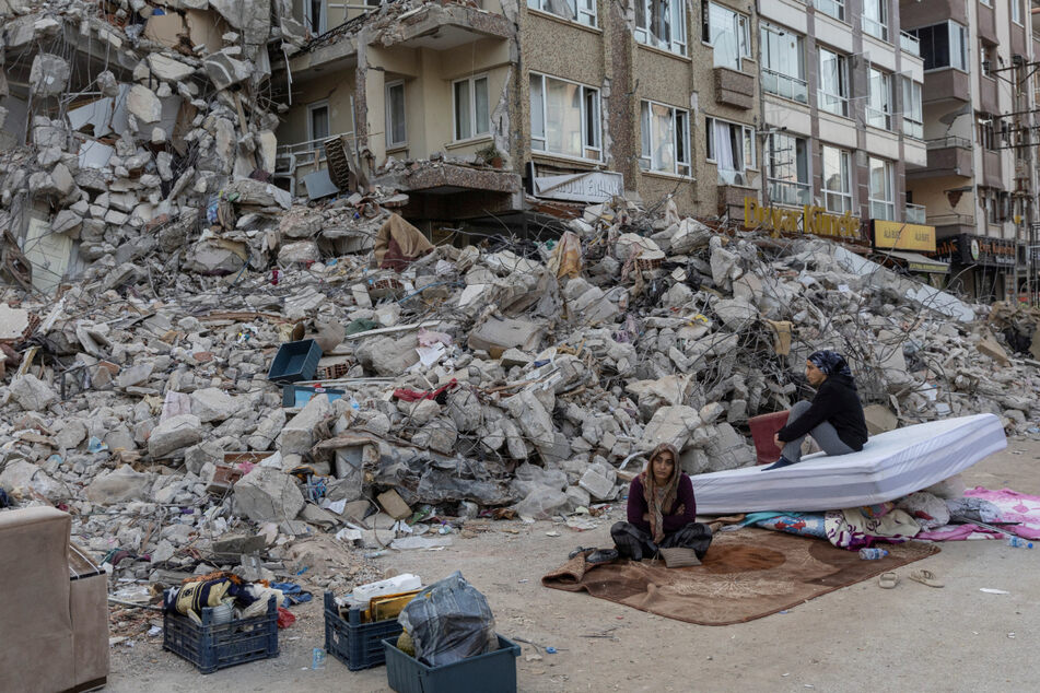 Residents outside a destroyed building as more deadly earthquakes hit the region in Antakya in Hatay province, Turkey.