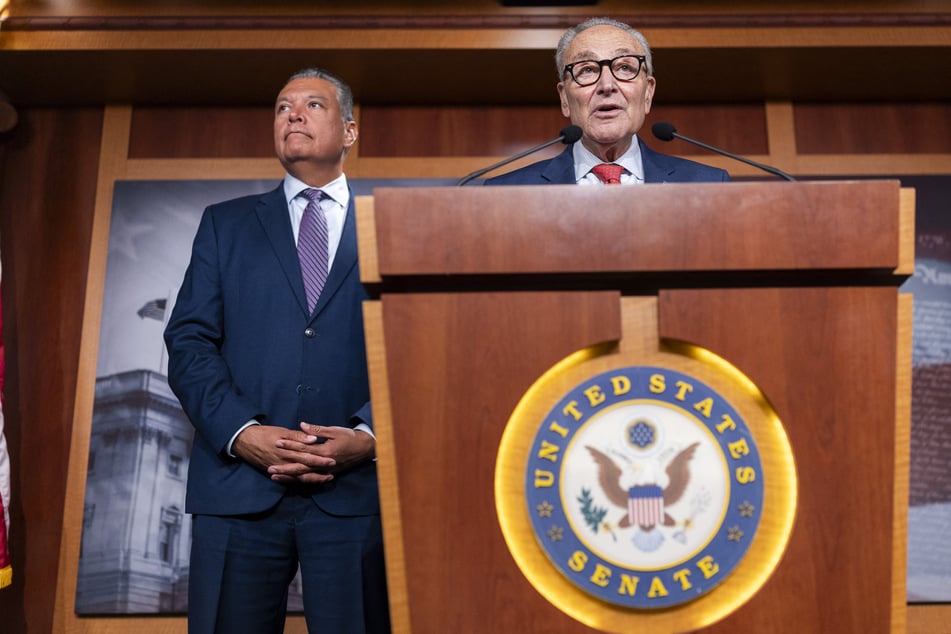 Sen. Alex Padilla (l.) looks on as Senate Minority Leader Chuck Schumer speaks during a press conference at the US Capitol on September 14. The two Democrats spoke to reporters on Wednesday about their election monitoring efforts.