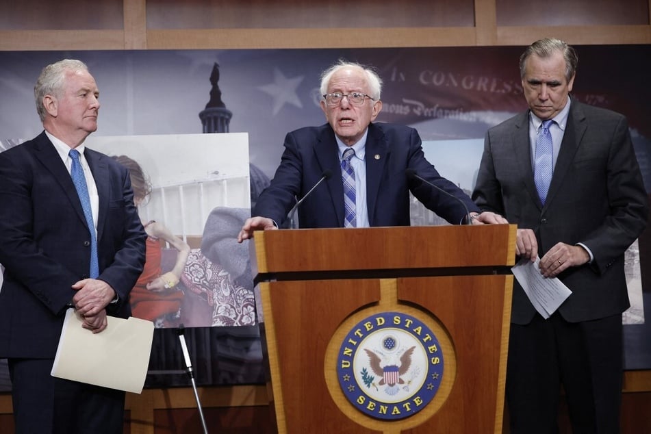 Senator Bernie Sanders (c.), joined by fellow Senators Chris Van Hollen (l.) and Jeff Merkley (r.), speaks at a news conference on restricting arms sales to Israel at the US Capitol on November 19, 2024.