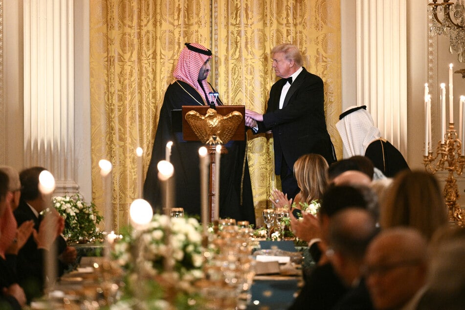 President Donald Trump (r) shakes hand with Crown Prince and Prime Minister of Saudi Arabia Mohammed bin Salman (l) during a dinner in the White House on November 18, 2025.