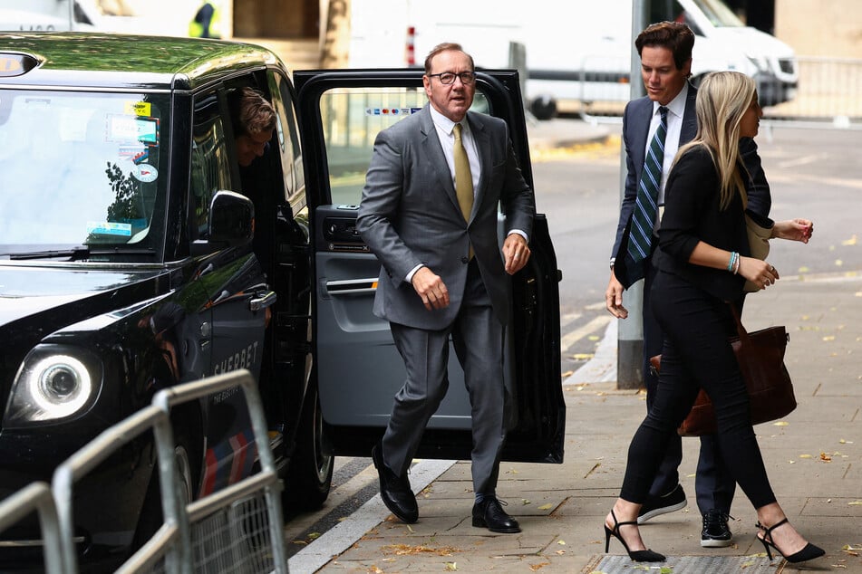 Kevin Spacey walks outside the Southwark Crown Court in London on the day of his trial over charges related to allegations of sex offenses.