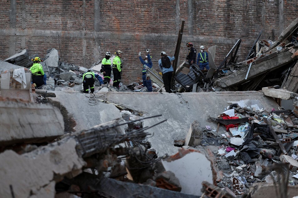 Emergency personnel work at the site of a damaged building following an earthquake, in Pereira, Colombia, on August 11, 2026.
