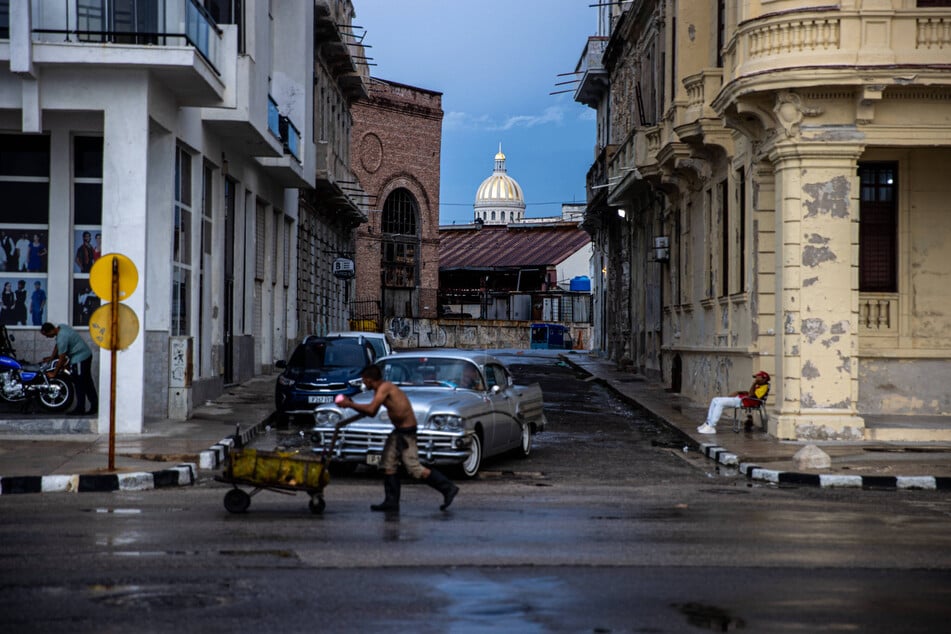 A man pushes a cart in Havana during another nationwide blackout on Wednesday, brought on by the US' punishing embargo.