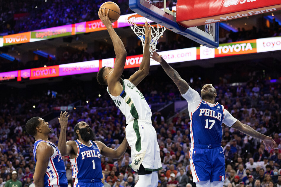 Milwaukee Bucks forward Giannis Antetokounmpo drives for a shot against Philadelphia 76ers forward P.J. Tucker and guard James Harden during the fourth quarter at Wells Fargo Center.