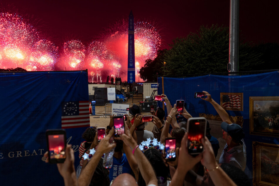 People watch an attempt at the largest firework display in history in Washington DC in the early hours of July 5, 2026.
