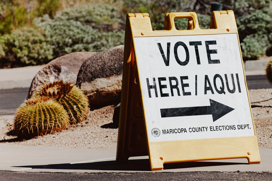 A sign points to a voting center in Scottsdale, Arizona, on October 7, the first day of early voting for the midterm elections. Activists have begun deploying volunteers to push back against possible voter intimidation.