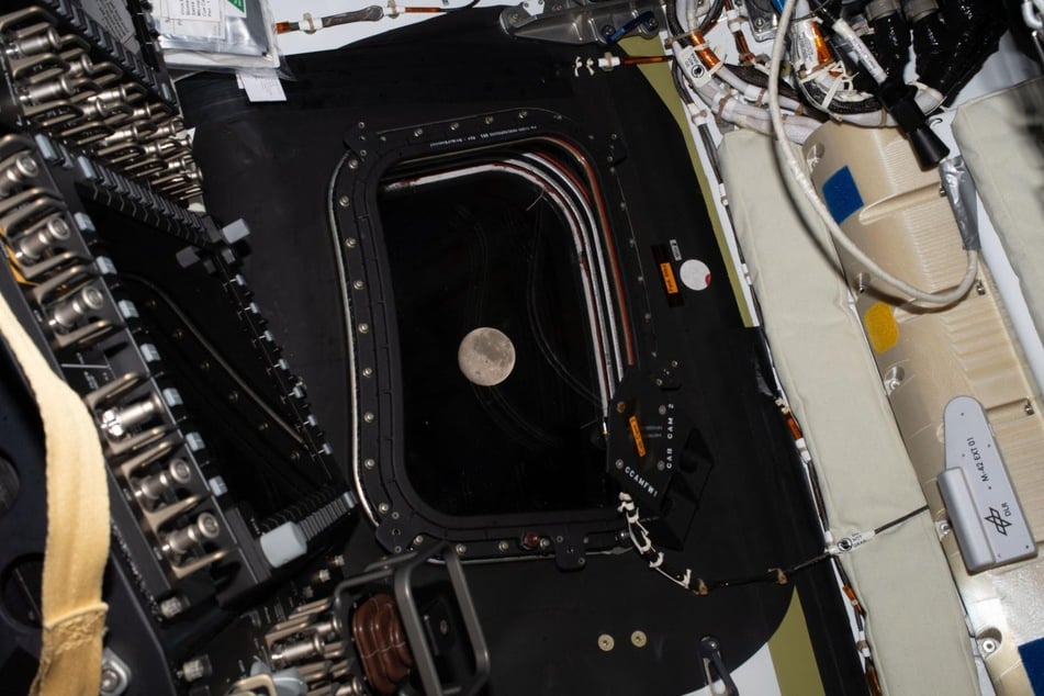 This handout picture by an Artemis II crew member provided by NASA shows the moon through a window of the Orion spacecraft on Monday.