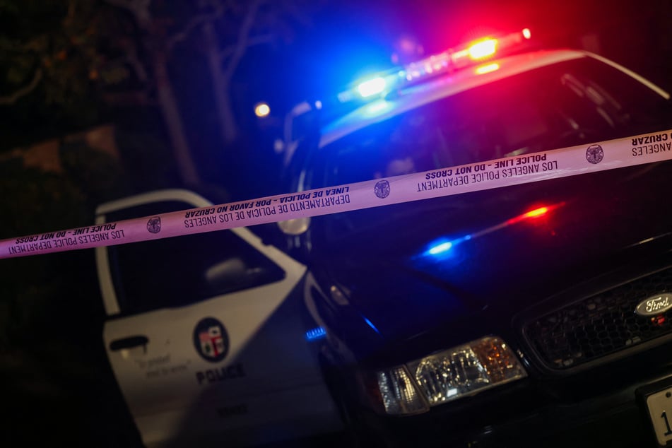 A Los Angeles Police Department patrol car is seen behind police tape blocking the access to a house in the Brentwood neighborhood of Los Angeles, California, on Sunday.
