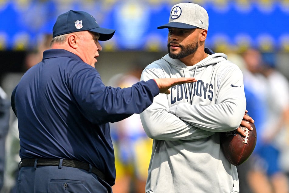 Dallas Cowboys head coach Mike McCarthy talks with quarterback Dak Prescott on the field prior to the game against the Los Angeles Rams at SoFi Stadium.