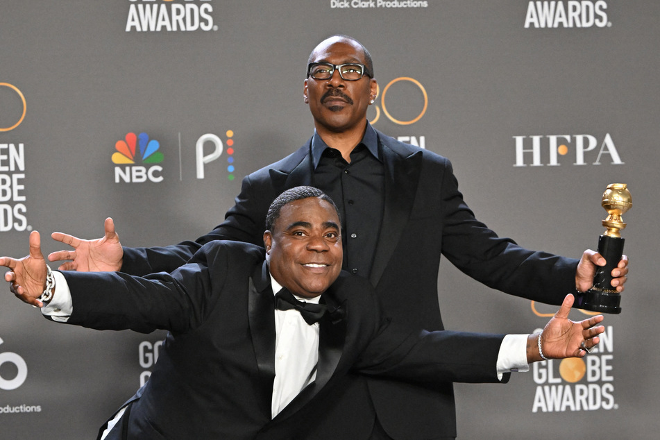Cecil B. DeMille honoree Eddie Murphy (r) and Tracy Morgan strike a pose on the Golden Globes red carpet.