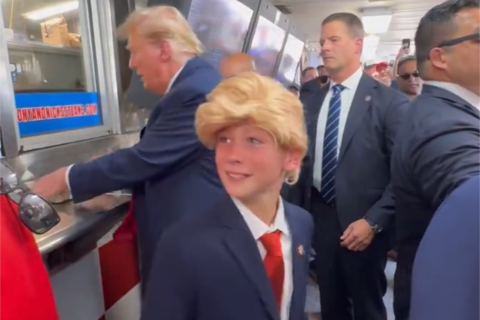 Superfan Timmy (c.) came Philadelphia in a his best Trump costume.