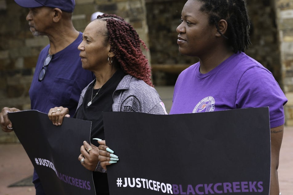 Supporters hold "Justice for Black Creeks" signs outside the Muscogee Nation District Court in Okmulgee, Oklahoma, on April 4, 2023.